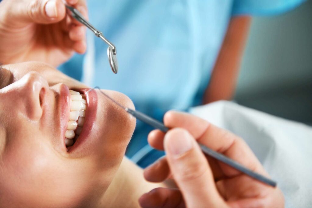 Picture of a female patient getting a routine dental cleaning.
